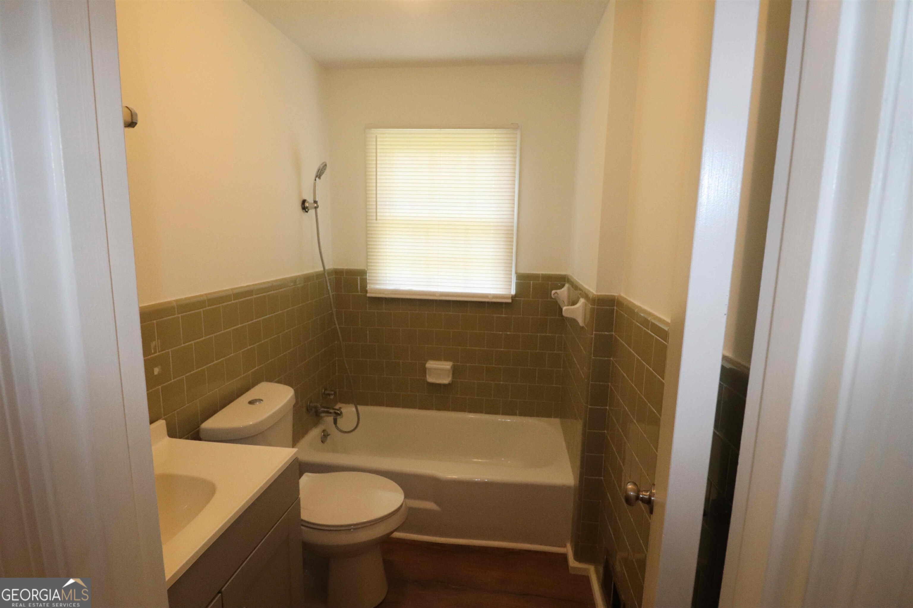 156 Deacon J Simmons Road Southwest Milledgeville, GA 31061 - Photo 16 of 22 a bathroom with a granite countertop toilet a sink and bathtub