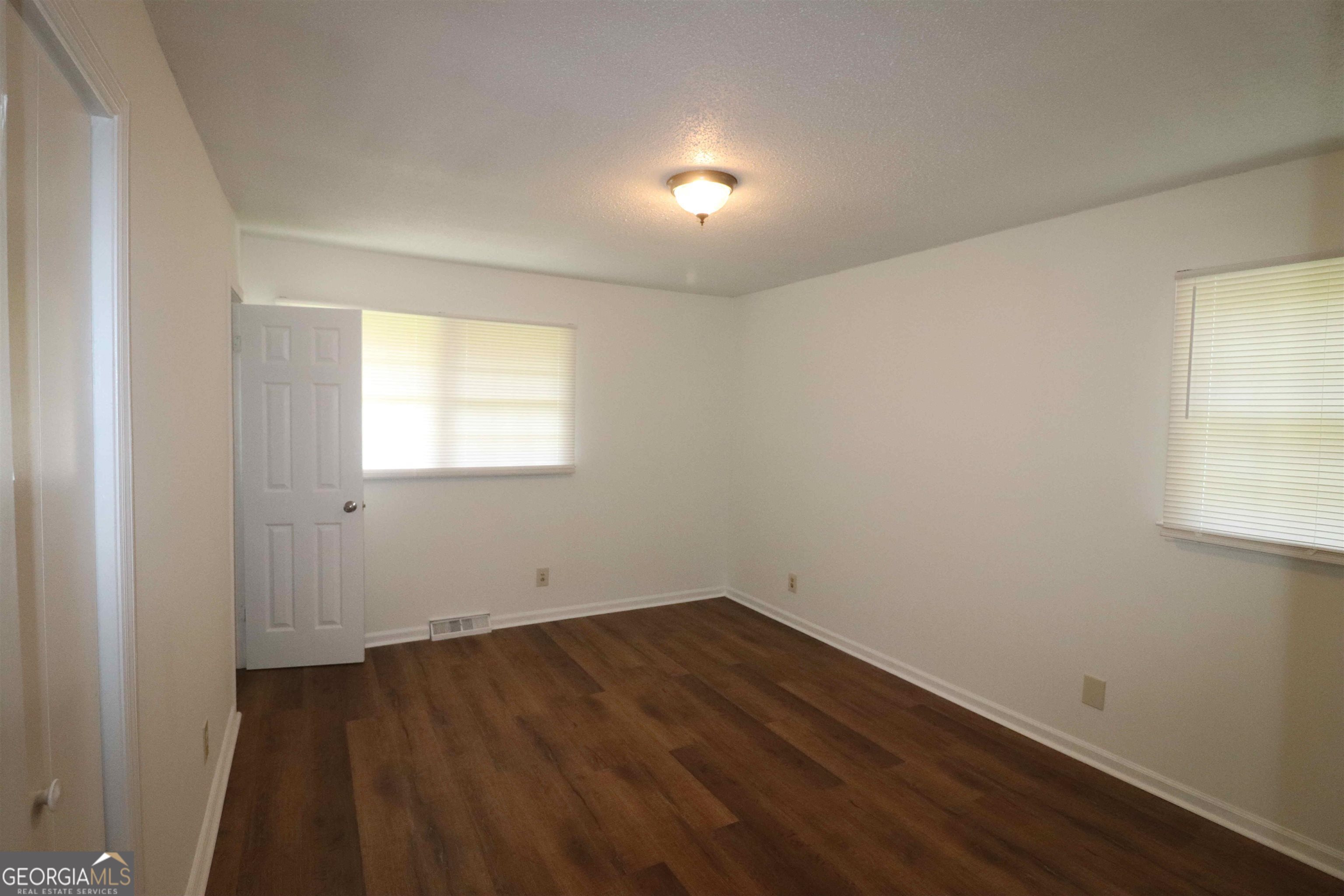 156 Deacon J Simmons Road Southwest Milledgeville, GA 31061 - Photo 6 of 12 an empty room with a window