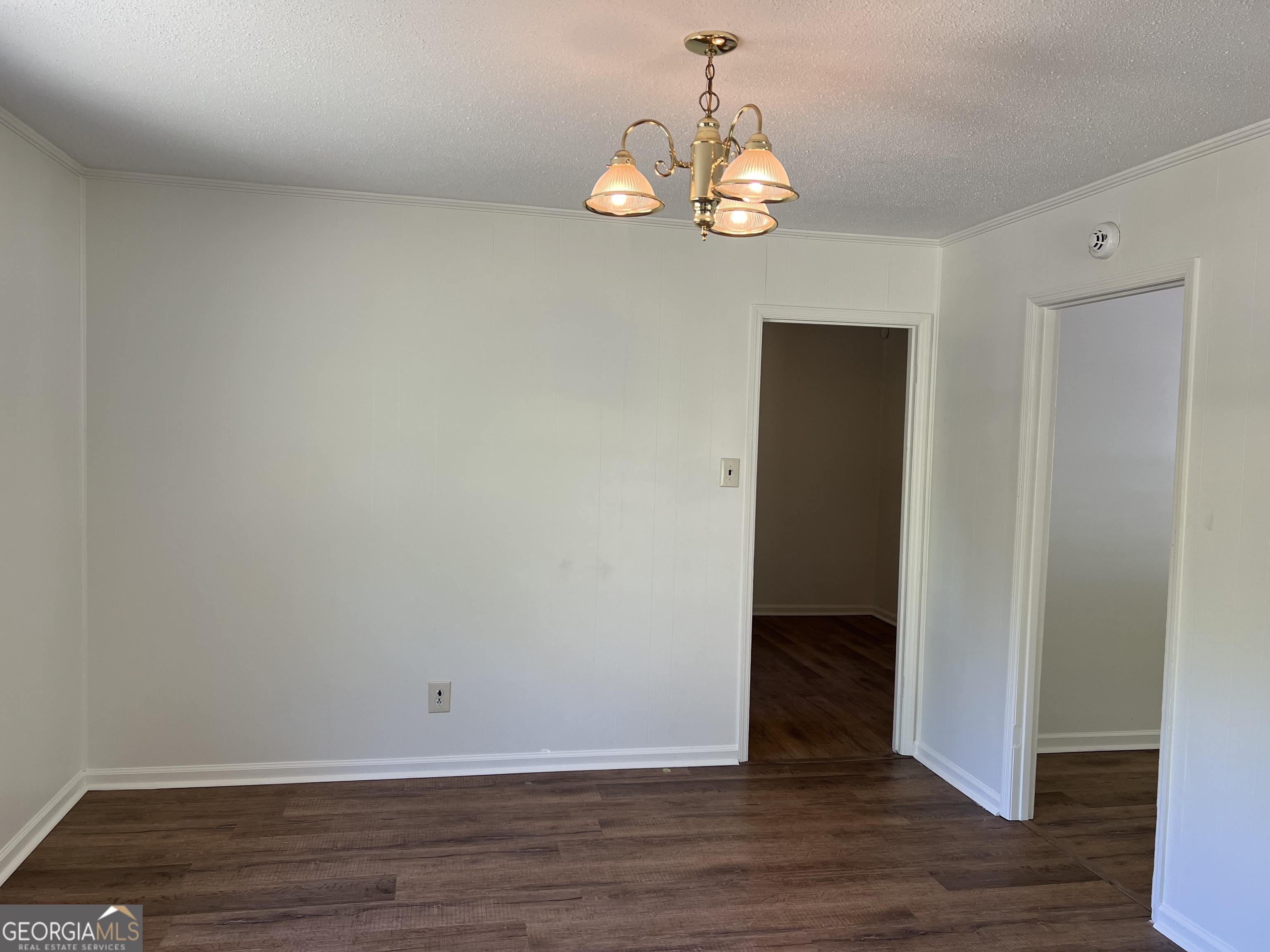156 Deacon J Simmons Road Southwest Milledgeville, GA 31061 - Photo 7 of 22 a view of an empty room with wooden floor and a window