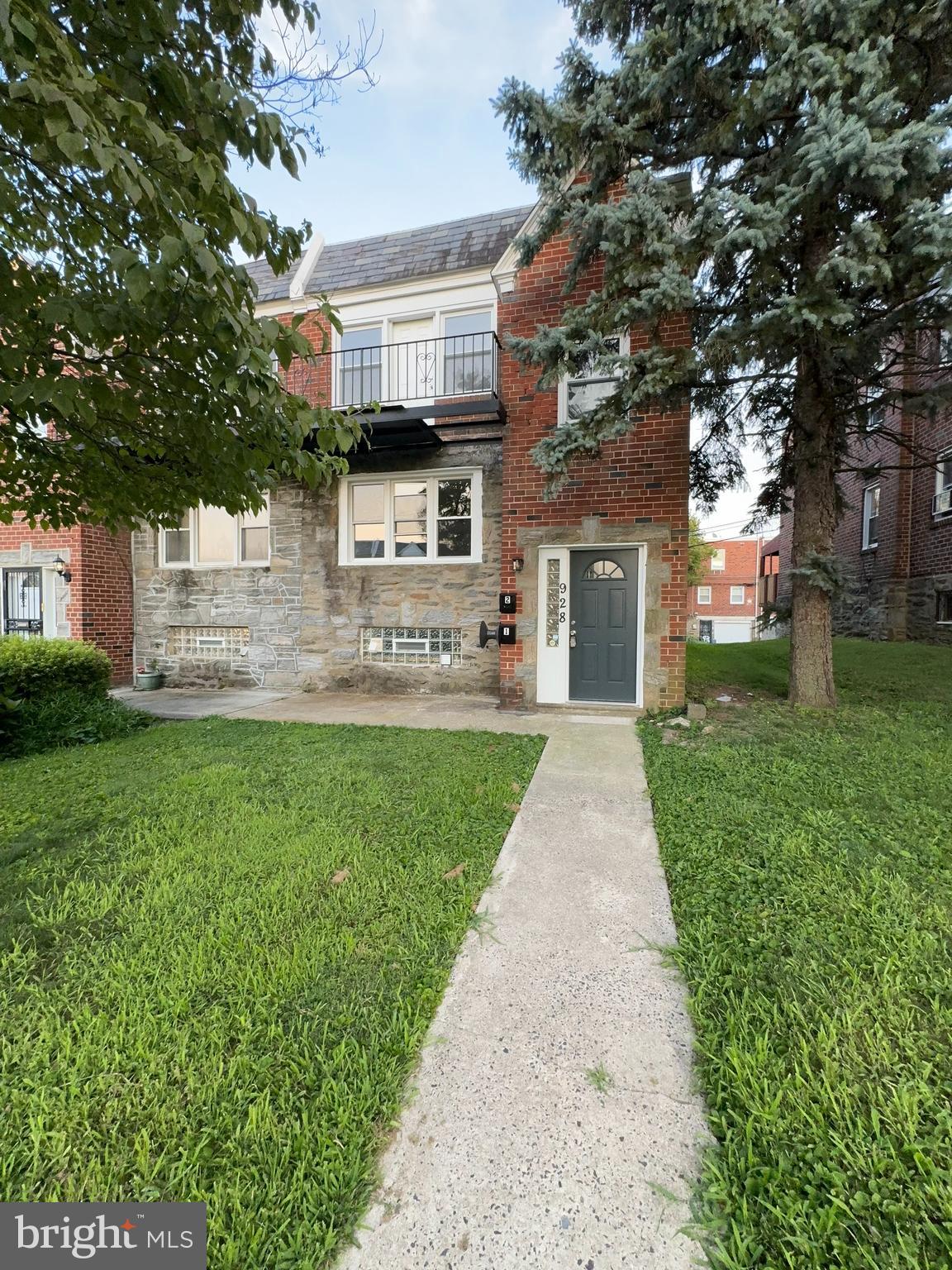 a front view of a house with a yard and a garden