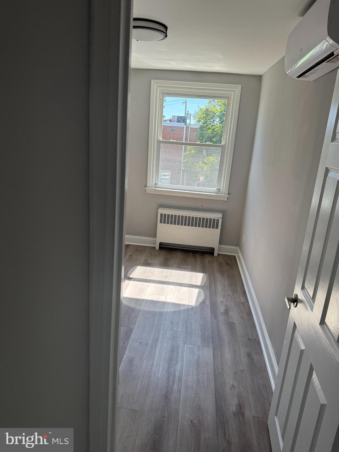 928 Durard Street Philadelphia, PA 19150 - Photo 5 of 8 an empty room with wooden floor and windows