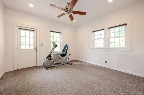 a view of a room with gym equipment and windows
