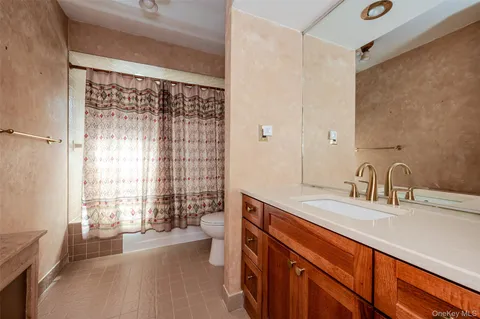 a bathroom with a sink a large mirror and a bathtub