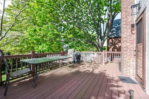 a view of a roof deck with wooden floor and fence