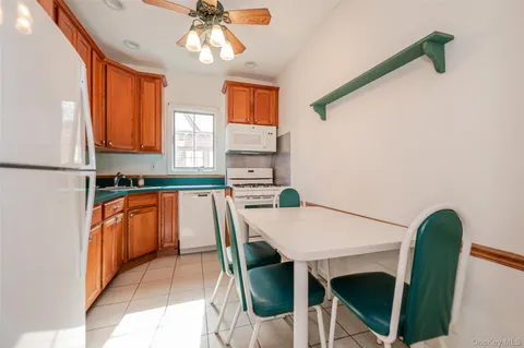 a kitchen with granite countertop a table chairs a sink and dishwasher