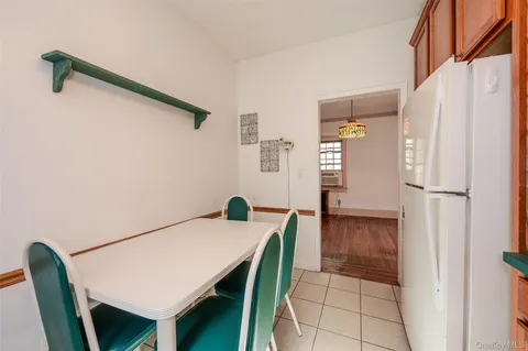 a kitchen with stainless steel appliances a refrigerator and a table