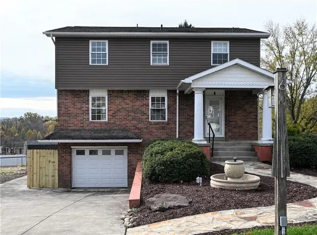 a front view of a house with stairs