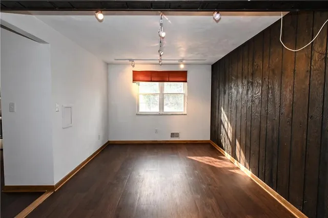 a view of a room with wooden floor and windows