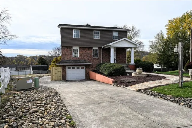 a front view of a house with garden