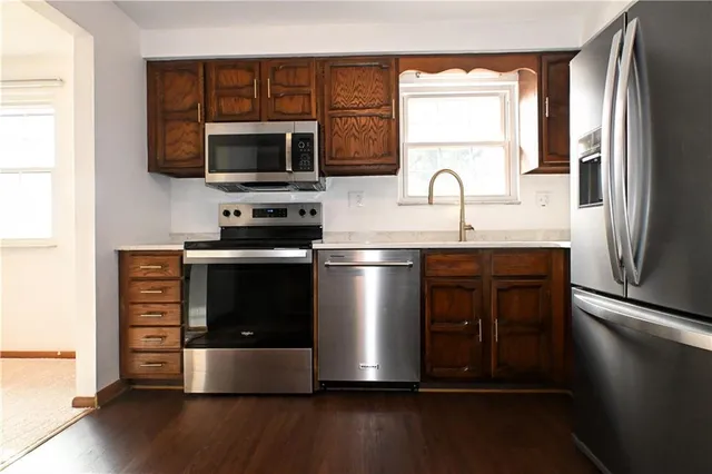 a kitchen with stainless steel appliances a microwave a stove and a refrigerator