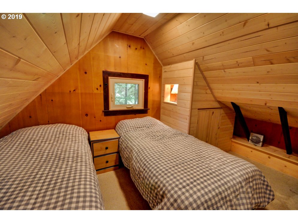 75774 East Road 28 Rhododendron, OR 97049 - Photo 18 of 26 a bedroom with a bed and wooden floor