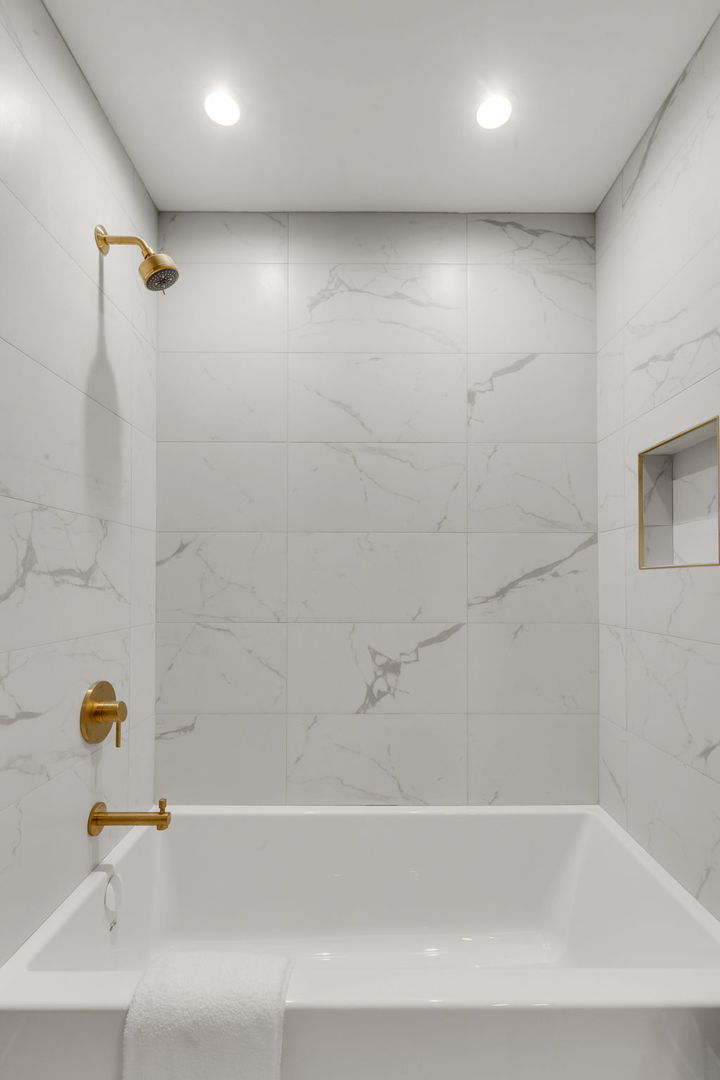 3204 North Kostner Avenue, Unit 506 Chicago, IL 60641 - Photo 19 of 23 a bathroom with a bathtub