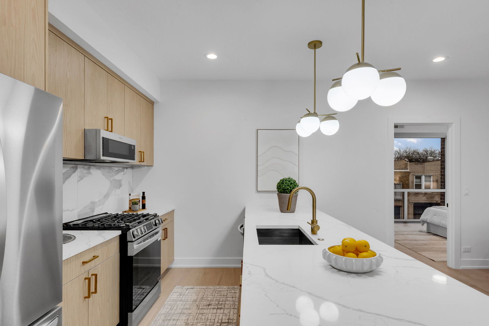 3204 North Kostner Avenue, Unit 506 Chicago, IL 60641 - Photo 8 of 23 a kitchen with a refrigerator a stove a sink and a chandelier