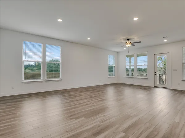 a kitchen with stainless steel appliances granite countertop wooden floors sink and cabinets