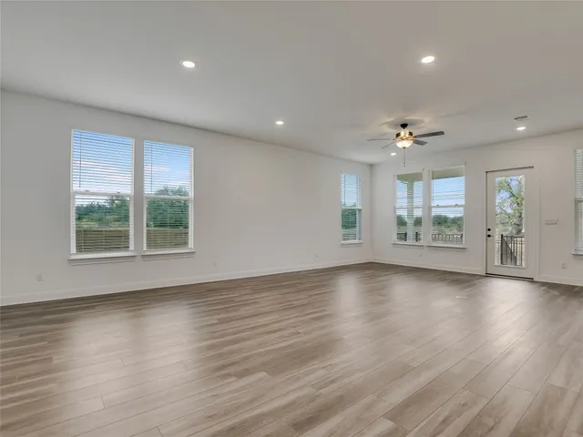 a kitchen with stainless steel appliances granite countertop wooden floors sink and cabinets