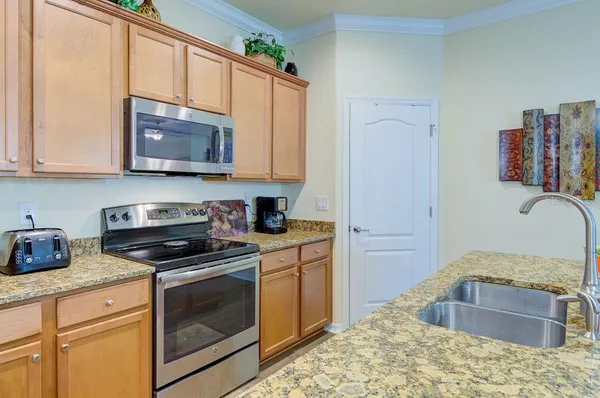 a bedroom with a bed a chandelier and a window