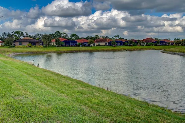 a view of a house with swimming pool and sitting area