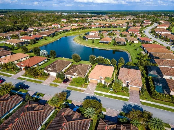 an aerial view of residential houses with outdoor space and river