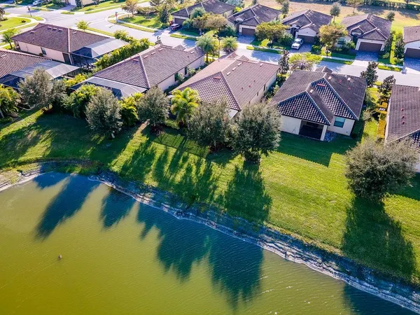 an aerial view of a house with outdoor space and lake view