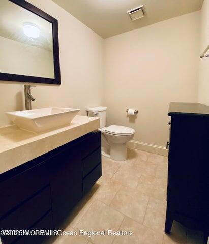 5 Alameda Court Eatontown, NJ 07724 - Photo 10 of 12 a bathroom with a toilet sink and mirror