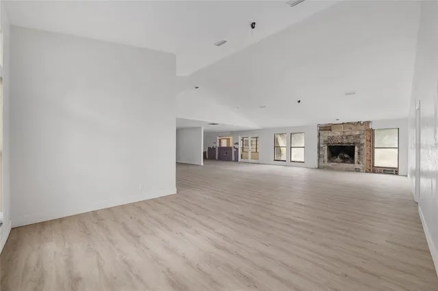 wooden floor fireplace and natural light in room