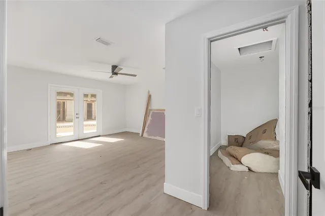 a view of an empty room and wooden floor and a cabinet