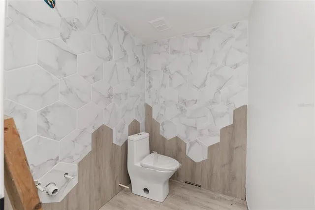 a white toilet sitting next to a shower curtain