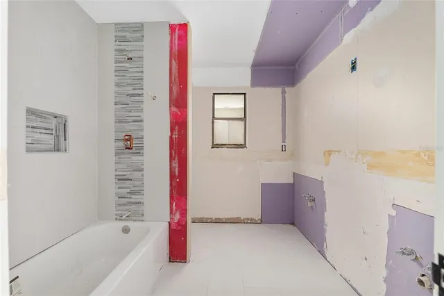 a bathroom with a bathtub and shower