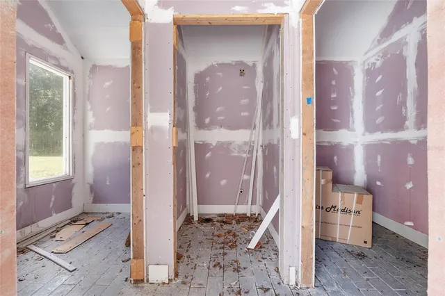 a view of a pathway of a house with a big yard and potted plants