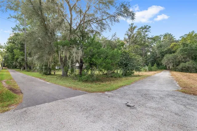 a view of a patio and yard in front of the house