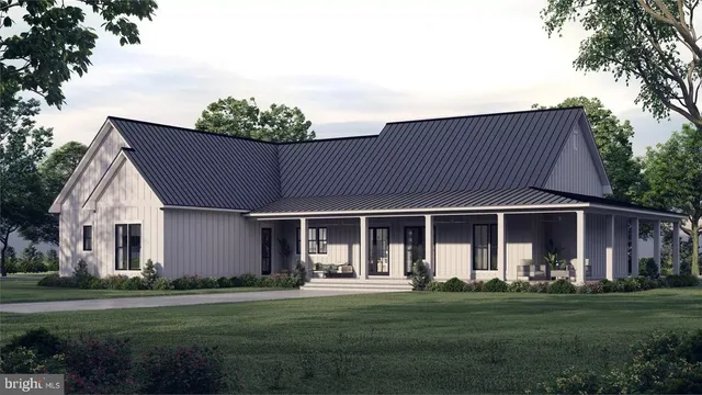 a front view of a house with a garden and trees