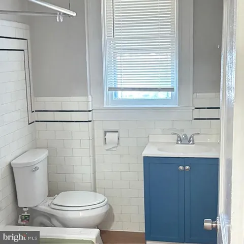 a bathroom with a toilet a sink and a window