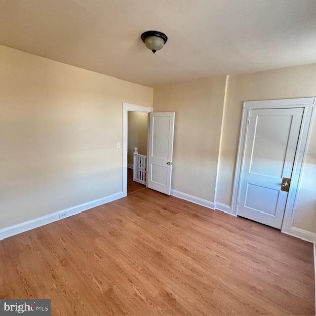 2891 Pelham Avenue Baltimore, MD 21213 - Photo 6 of 11 a view of an empty room and wooden floor