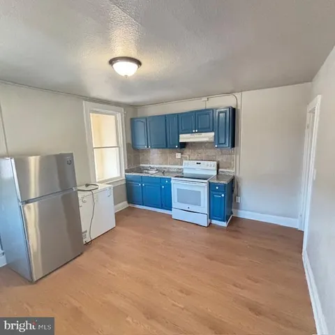 a kitchen with stainless steel appliances granite countertop a refrigerator sink and cabinets