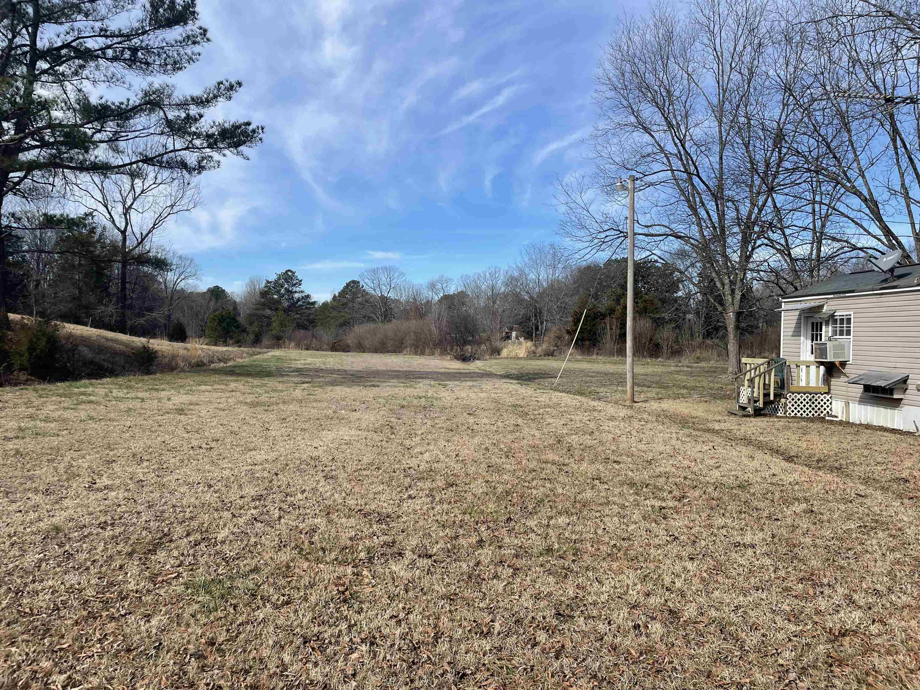 4130 Henderson Road Sardis, TN 38371 - Photo 10 of 14 a backyard of a house with lots of green space