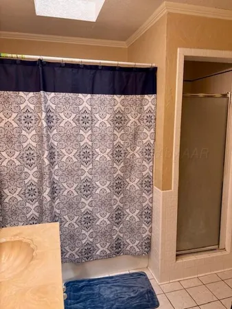 a wooden bench sitting in a bedroom next to a window