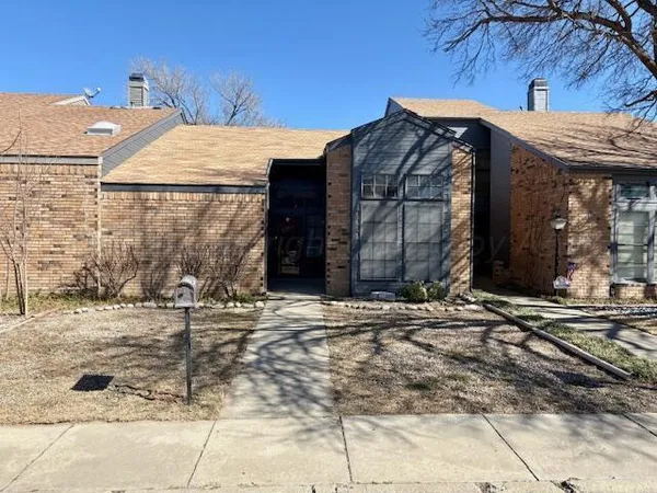 a view of a house with a door and wooden fence