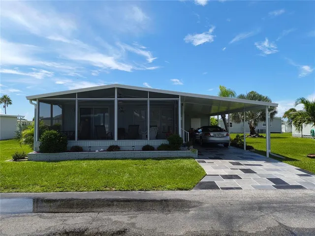 a view of a house with a yard porch and sitting area
