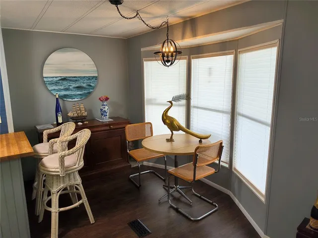 a view of a room that has a table and chairs