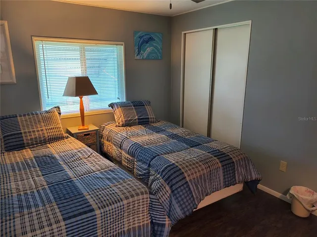 a bedroom with a bed and a lamp