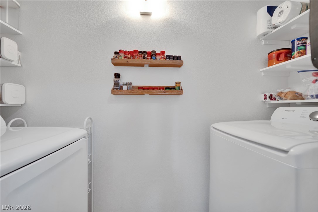7570 West Flamingo Road, Unit 115 Las Vegas, NV 89147 - Photo 12 of 34 Functional laundry space offering convenient vertical storage shelves for household essentials.