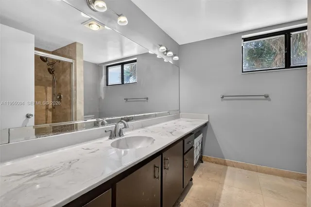 a bathroom with a glass shower door