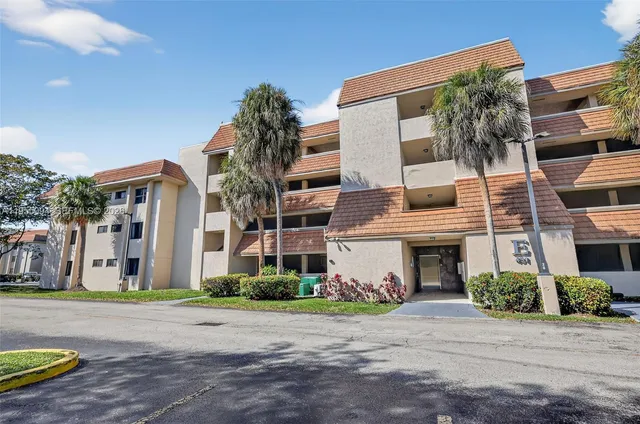 a view of a white house with a yard