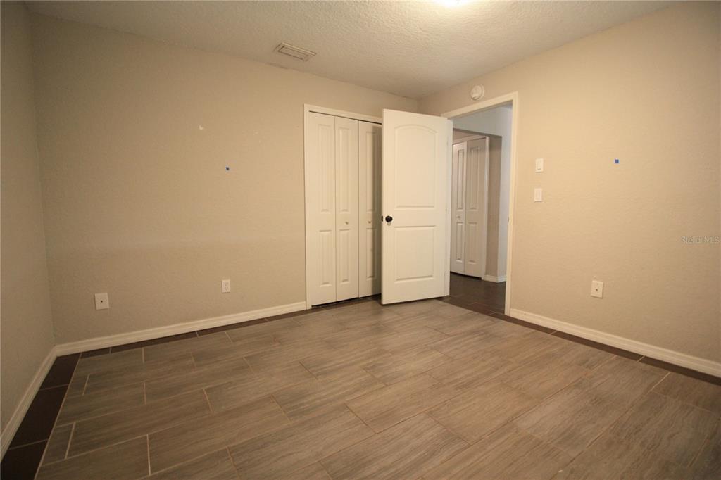 6101 Southeast Foss Road, Unit 4 Belleview, FL 34420 - Photo 11 of 19 a view of an empty room and wooden floor