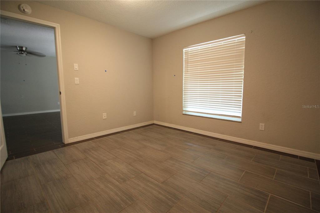 6101 Southeast Foss Road, Unit 4 Belleview, FL 34420 - Photo 12 of 19 a view of an empty room with a window