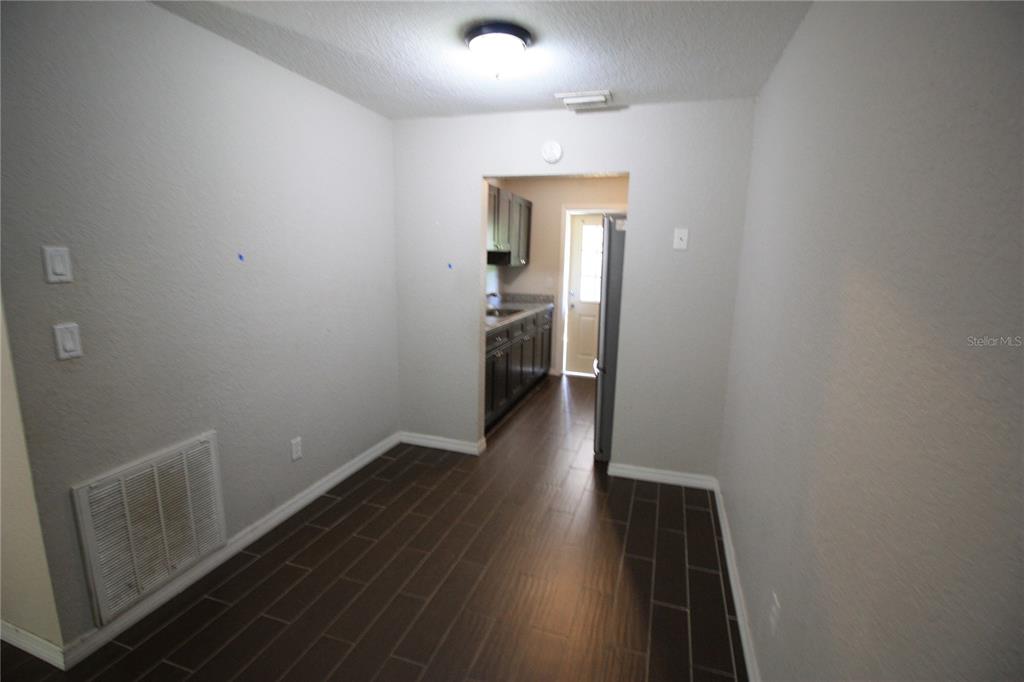 6101 Southeast Foss Road, Unit 4 Belleview, FL 34420 - Photo 14 of 19 a view of hallway with wooden floor