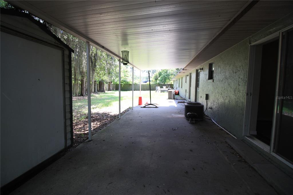 6101 Southeast Foss Road, Unit 4 Belleview, FL 34420 - Photo 17 of 19 a view of a porch with furniture