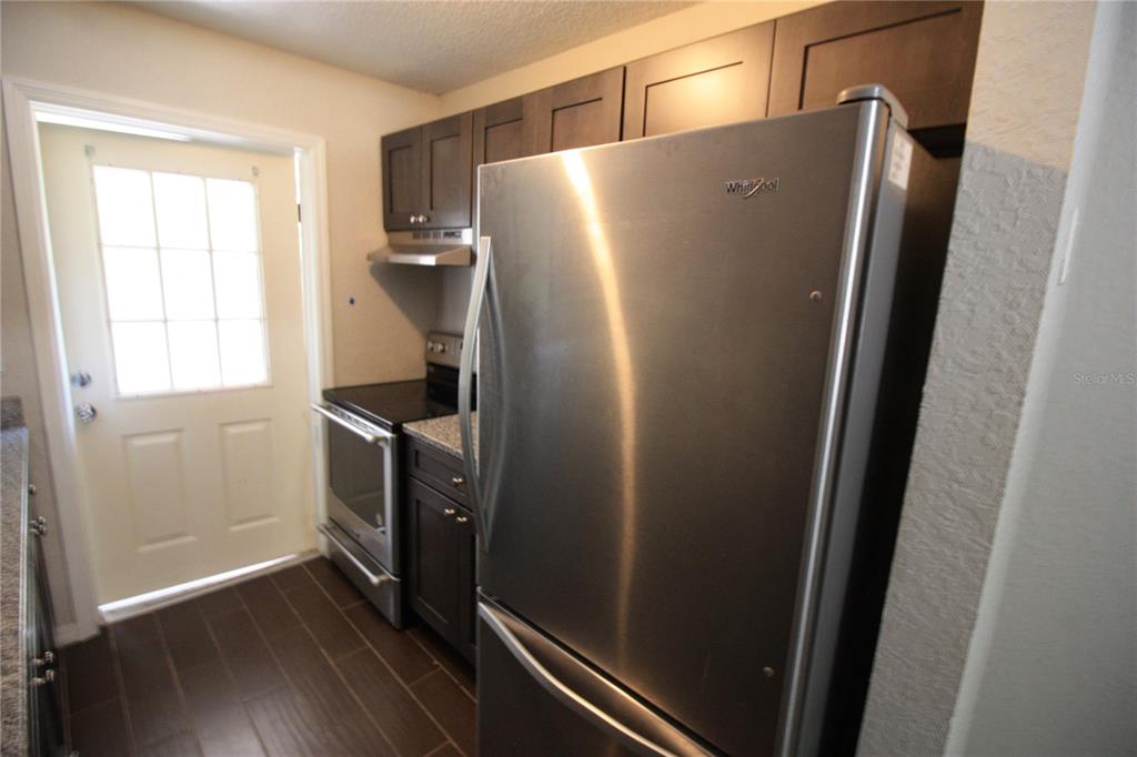 6101 Southeast Foss Road, Unit 4 Belleview, FL 34420 - Photo 3 of 19 a refrigerator freezer sitting inside of a kitchen