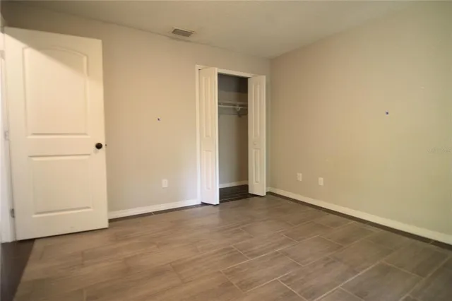 a view of an empty room with closet area