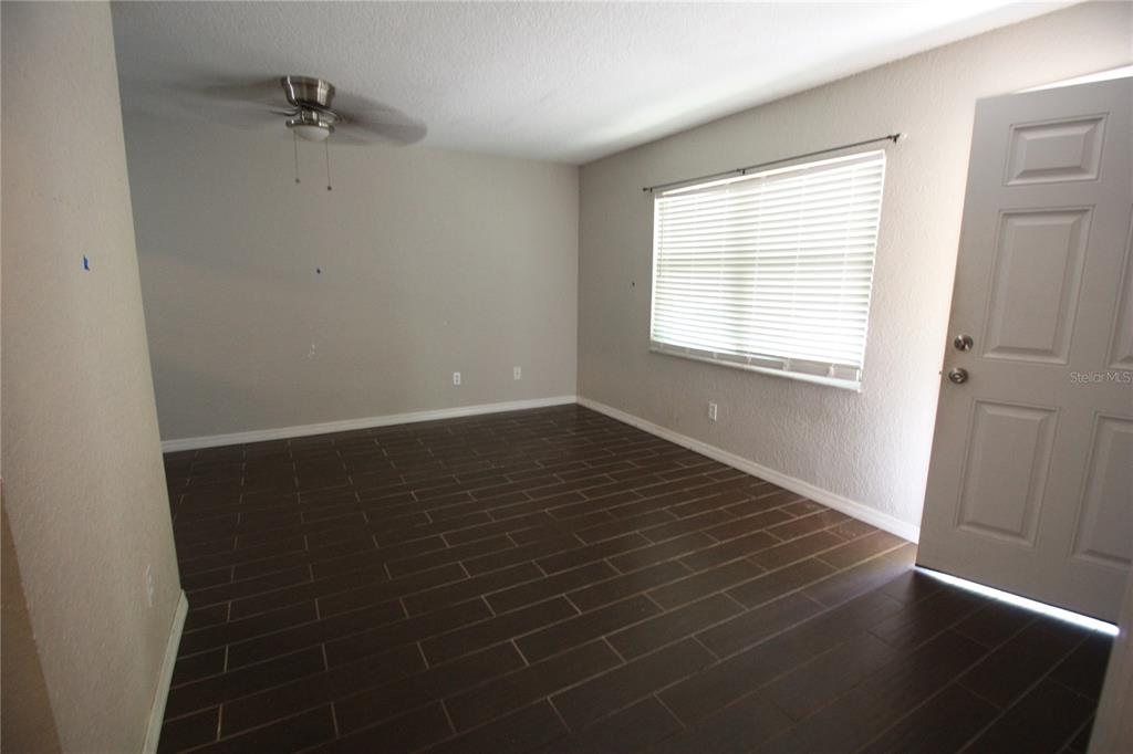 6101 Southeast Foss Road, Unit 4 Belleview, FL 34420 - Photo 10 of 19 a view of an empty room with wooden floor and a window